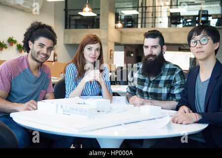 Team of architects with building model, portrait Stock Photo