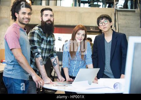 Team of colleagues working together on project in office Stock Photo