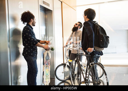 Men waiting for elevator Stock Photo