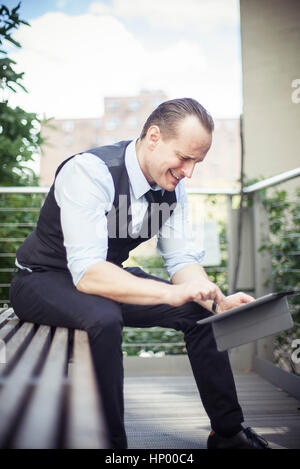 Businessman using digital tablet outdoors Stock Photo
