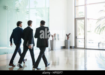 Business associates chatting while walking together Stock Photo