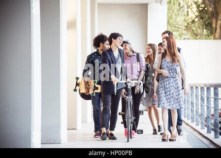 Group of coworkers chatting as they leave the office together Stock Photo