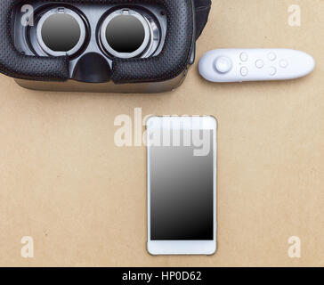virtual glasses and joy stick on brown paper background Stock Photo