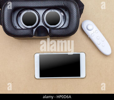 virtual glasses and joy stick on brown paper background Stock Photo