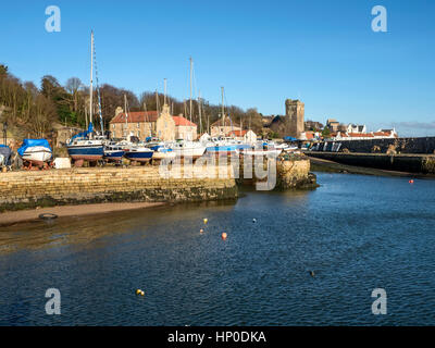 Boats on the quayside at the Dysart Harbour with the Harbour House and Sr Serfs Kirk behind Dysart Kirkcaldy Fife Scotland Stock Photo