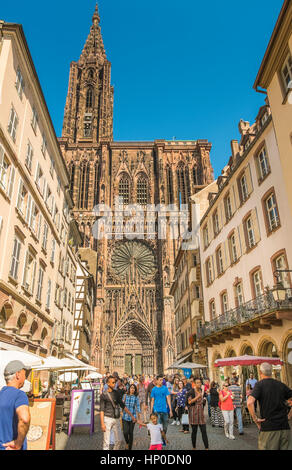 street scene in front of west facade of strasbourg cathedral seen from rue merciere Stock Photo
