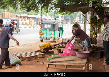 COLOMBO, SRI LANKA - NOVEMBER 28, 2013 : street vendors preparing stall for sell vegetables on small street market in Colombo, Sri Lanka on November 2 Stock Photo