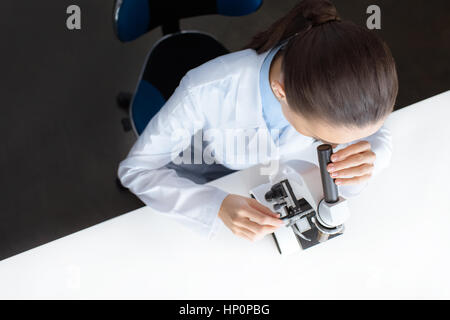 scientist working with microscope in laboratory Stock Photo