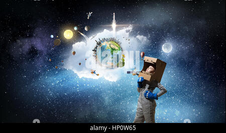 Cute school girl wearing helmet and astronaut costume. Elements of this image are furnished by NASA Stock Photo