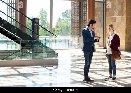 Couple talking in hotel lobby Stock Photo