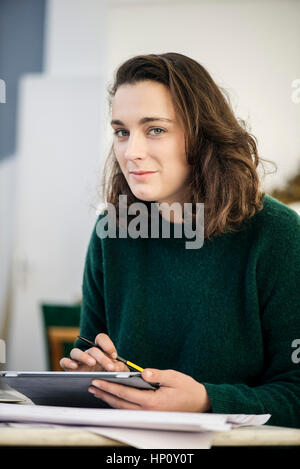 Woman using digital tablet, portrait Stock Photo