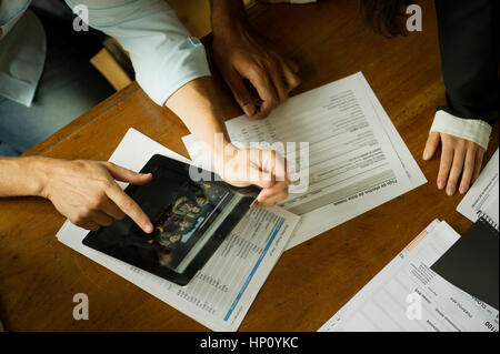 Colleagues using digital tablet during meeting Stock Photo