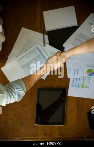 Business associates shaking hands during meeting Stock Photo