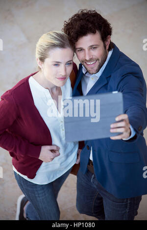Couple using digital tablet to take a selfie Stock Photo