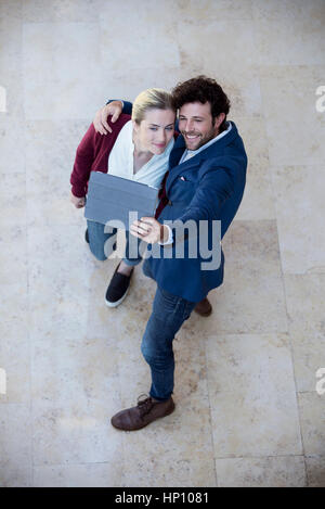 Couple using digital tablet to take a selfie Stock Photo