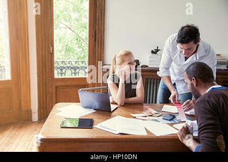 Designers looking at color swatches in office Stock Photo