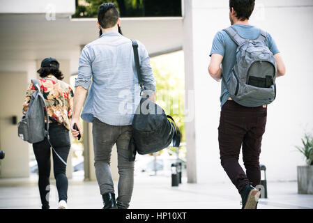 College students walking on campus, rear view Stock Photo