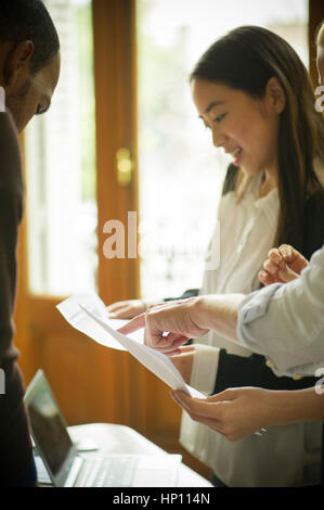 Office workers discussing documents Stock Photo