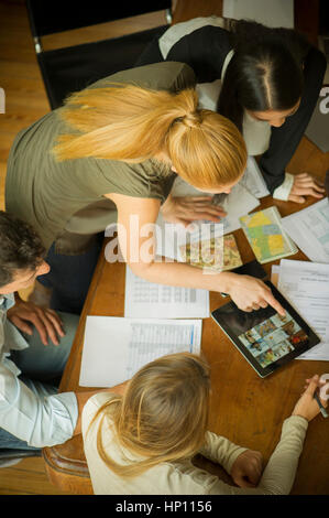 Business associates using digital tablet during meeting Stock Photo