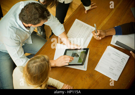 Colleagues using digital tablet during meeting Stock Photo