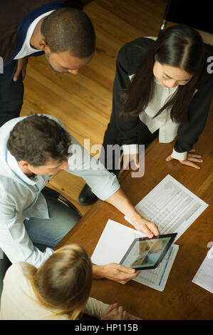 Colleagues using digital tablet during meeting Stock Photo