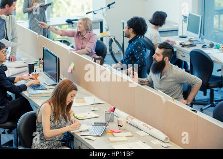 Professionals coworking in shared office space Stock Photo