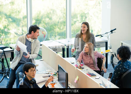 Colleagues interacting in casual office Stock Photo