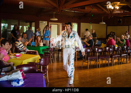 Elvis i,personator reenactor at senior citizens birthday party. Stock Photo