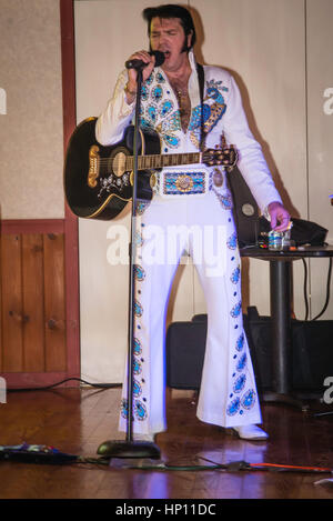 Elvis i,personator reenactor at senior citizens birthday party. Stock Photo