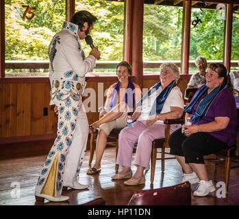 Elvis i,personator reenactor at senior citizens birthday party. Stock Photo