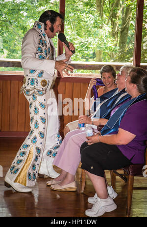 Elvis i,personator reenactor at senior citizens birthday party. Stock Photo