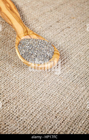 Close up of Chia seeds in a wooden spoon, space for text. Stock Photo
