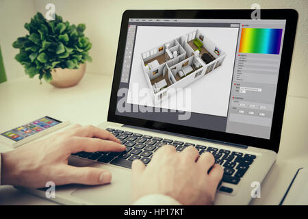 Hands using laptop on desktop with interior design software Stock Photo