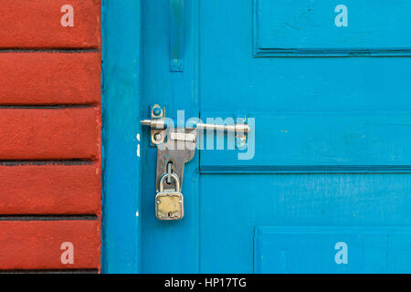 Padlocked door with bolt on the Indian subcontinent Stock Photo