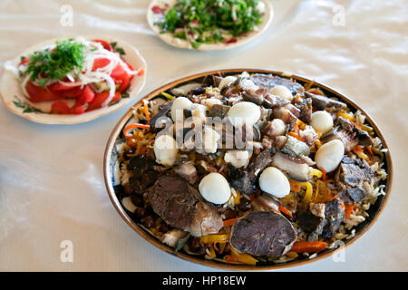 Uzbek national dish pilaf on a plate in a Bukhara restaurant Stock Photo