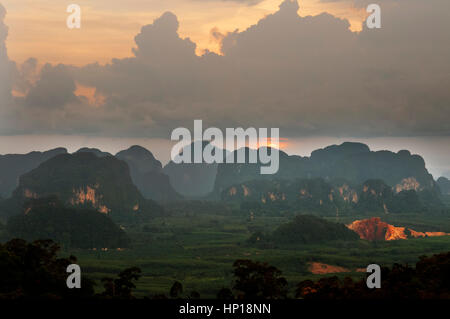 Sunset view of the beauty mountains from Buddhist shrine and statue on top of the mountain towards Tiger Cave Temple (Wat Tham Sua), Krabi, Thailand.  Stock Photo