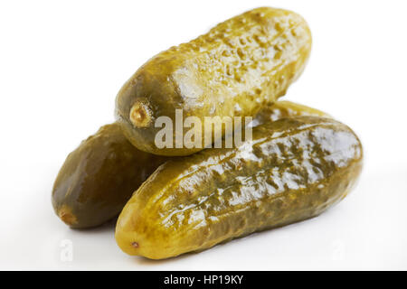 Three preserved pickled cucumbers isolated on white background Stock Photo