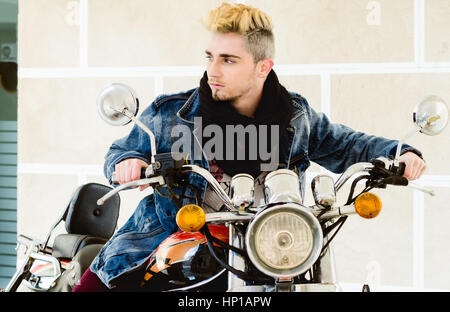 Handsome fashion man sitting on classical motorcycle. Stock Photo