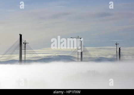 Inverkeithing, Scotland, UK. 17th February, 2017. The towers of the new Queensferry Crossing bridge across the Forth Estuary rise out of the morning mist, Credit: Ken Jack/Alamy Live News Stock Photo