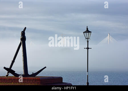 Inverkeithing, Scotland, UK. 17th February, 2017. The towers of the new Queensferry Crossing bridge across the Forth Estuary rise out of the morning mist, viewed from the seafront at St David's Harbour, Dalgety Bay, Credit: Ken Jack/Alamy Live News Stock Photo