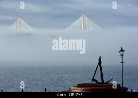 Inverkeithing, Scotland, UK. 17th February, 2017. The towers of the new Queensferry Crossing bridge across the Forth Estuary rise out of the morning mist, viewed from the seafront at St David's Harbour, Dalgety Bay, Credit: Ken Jack/Alamy Live News Stock Photo