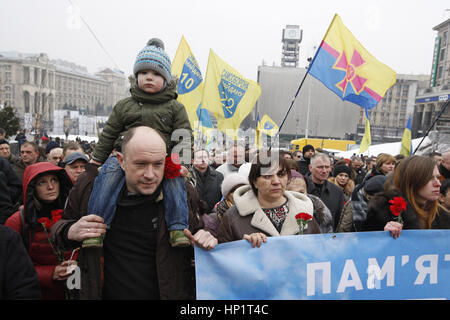 Kiev, Ukraine. 18th Feb, 2017. Ukrainians carry a banner reading ''We remember of the Heroes of the Heavenly Hundred'' during march in Kiev, Ukraine, on 18 February 2017. Ukrainians mark the third anniversary of the escalated violence in Maidan during anti-government protests in 2014, where being killed at least 100 people. Credit: Serg Glovny/ZUMA Wire/Alamy Live News Stock Photo