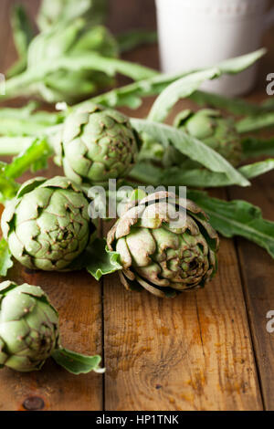 Globe Artichokes on Wooden Surface Stock Photo