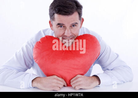 Model release , Attraktiver Mann, 50+, mit Stoffherz - attractive man, with heart Stock Photo