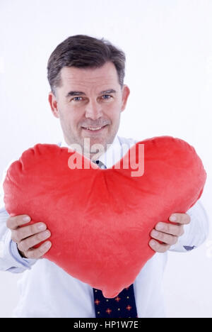 Model release , Attraktiver Mann, 50+, mit Stoffherz - attractive man, with heart Stock Photo