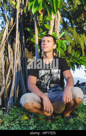 A Relaxed attractive smiling man sit on. Stock Photo