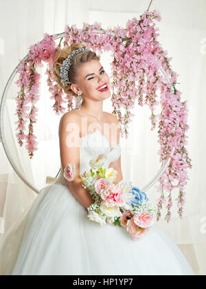 portrait of blonde bride in the interior. wedding dress, make-up Stock Photo