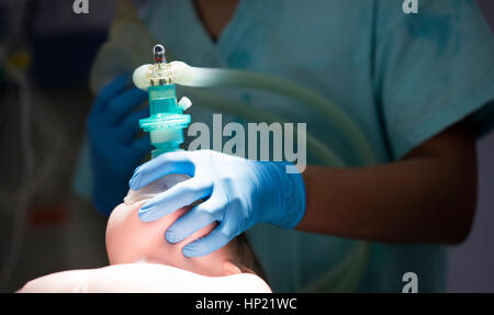 anesthesiologist gives the mask inhalation anesthesia Stock Photo