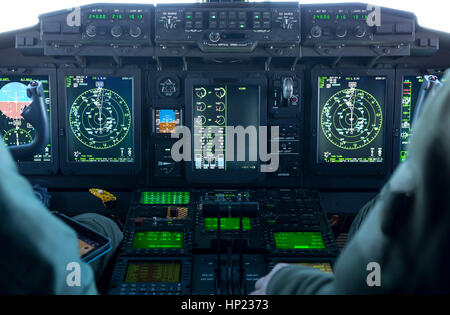 A cockpit of a military carrier airplane during flight. Pilots flying the machine. Spartan airplane. Stock Photo