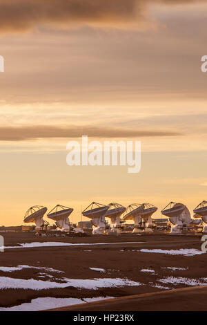 sunset, ALMA observatory, Antennas in plain of Chajnantor, 5000 meters of altitude,Array Operations Site (AOS), Atacama desert. Chile Stock Photo